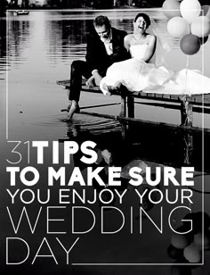 a bride and groom sitting on a bench in the water with balloons floating around them