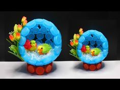 two plastic toys with flowers and birds in them