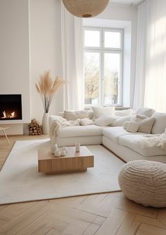 a living room filled with furniture and a fire place next to a window on top of a hard wood floor