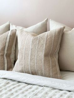 four pillows are lined up on the bed