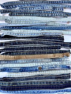 several different types of jeans stacked on top of each other