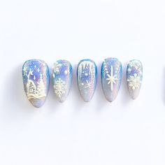 Step into a frosty fairytale with our Winter Wonderland press-on nails, a breathtaking combination of icy blues, glistening glitter, and intricate white details. Each nail captures the essence of a magical winter scene, with delicate snowflakes, twinkling stars, and a charming snowy village design. The shimmering base provides a radiant glow, reminiscent of snow-covered landscapes under a starry sky. These nails are perfect for anyone looking to add a dash of winter magic to their style. With their intricate detailing and sparkling finish, "Winter Wonderland" is sure to elevate your look for any holiday party, winter getaway, or cozy night in. 🎀 With every order we send an Essentials Tool Kit for free! What's included in the kit: 1 nail file  1 wooden stick  1 sheet with 24 sticky tabs 2 Iridescent Snowflake Nails, Pink And Blue Winter Nails, Winter Ice Nails, Snow Nails Winter White, Snowy Winter Nails, Tanzanite Nails, Frosty Winter Nails, Christmas Nails Dark Blue, Icy Winter Nails