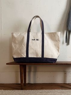 "Vintage LLBEAN canvas boat and tote bag.  Extra large (24\" wide) size with original monogram BJM INC. Nicely aged and lightly faded purple straps and bottom panel. Nice vintage patina with light age and use marks.  DIMENSIONS: 24\"W x 15\"H x 9\"D CONDITION:  very good vintage condition, strong and sturdy as it should be, with 2 single-layer holes in the bottom as shown (bottom layer only these do not go through!) The shop: http://www.etsy.com/shop/goseek" Vintage Cotton Canvas Bag With Large Capacity, Vintage Waxed Canvas Bag With Large Capacity, Vintage Everyday Canvas Bag, Vintage Canvas Bag With Canvas Lining, Vintage Cotton Bag With Leather Handles, Vintage Cotton Bags With Leather Handles, Vintage Canvas Bag With Large Capacity, Vintage Canvas Tote Bag For Shopping, Vintage Style Large Capacity Canvas Bag