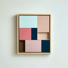 an abstract painting with different colors in a wooden frame