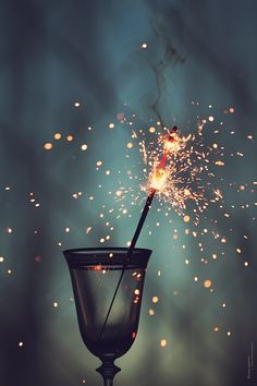 a sparkler in a glass with the words, oh la la let's go for another sparkling year