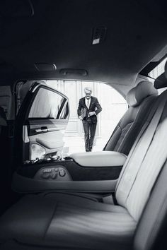 a man standing in the back seat of a car