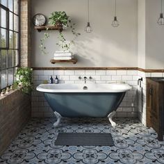 an old fashioned bathtub in a bathroom with brick walls and flooring, surrounded by potted plants