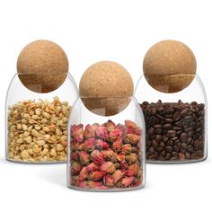 three glass containers filled with different types of nuts and grains in front of each other