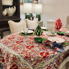 a dining room table with plates and cups on it