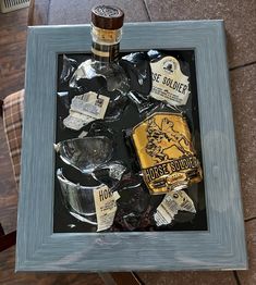 a bottle of liquor sitting on top of a table next to some ice cubes