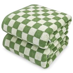 three green and white checkered towels stacked on top of each other