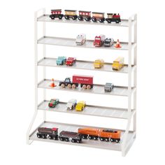 toy trucks and cars are lined up on the shelves in this white display case for children's toys