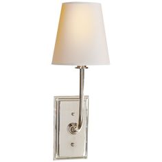 a wall light with a white shade on it