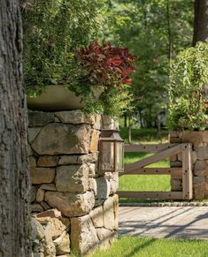 a stone wall with two planters on it