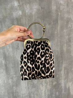 Handle vintage style purse frame bag with leopard pattern Add a touch of timeless elegance to your wardrobe with this stunning vintage-style purse frame bag. This bag combines classic design with a bold leopard print for a chic, statement-making accessory. Whether you're heading to a formal event or adding a fashionable twist to your everyday look, this bag is versatile, stylish, and perfect for any occasion. Fabric - tight jeans Size - 5.9x7 inch (15x18 cm) Let me know if any questions or you n Elegant Leopard Print Bag With Double Handle, Leopard Print Shoulder Bag With Double Handle, Animal Print Handbags, Vintage Designer Bags, Leopard Print Bag With Gold-tone Hardware For Daily Use, Handmade Fabric Bags, Leopard Print Shoulder Bag With Gold-tone Hardware, Clutches For Women, Printed Purse