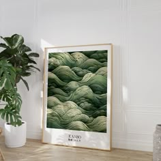 a framed photograph sitting on top of a wooden table next to a potted plant