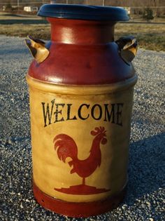 a welcome rooster canister sitting on gravel