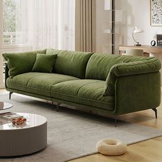 a living room with a green couch and coffee table