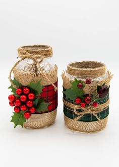 two mason jars decorated with holly berries and twine burlocks are sitting side by side