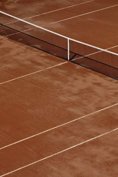 a man standing on top of a tennis court holding a racquet