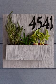 a wooden planter with plants in it and the number 544