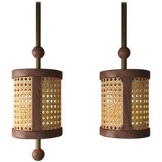 two lamps are hanging from the ceiling with brown and gold dots on them, one light is