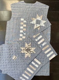 three quilted placemats on top of each other, one with a star design