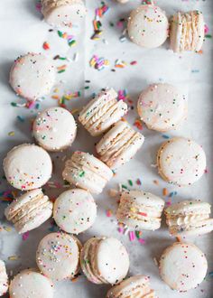 many white cookies with sprinkles and confetti