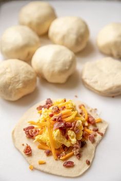 tortillas with eggs, cheese and bacon on them next to doughnuts