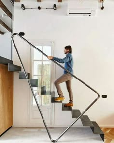 a man is climbing up the stairs in his house