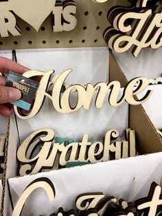 a person is holding some type of wood cutout letters in their hands and the words home grateful are placed on top of each other