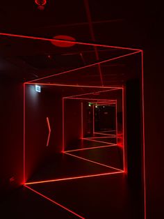 an empty room with red lights in it