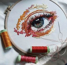 an embroidery project with two spools of thread next to each other