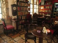 a room filled with lots of books and furniture