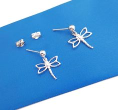 Ball posts with dragonfly charm drop earrings. This lovely and simple minimalistic earrings for everyday use, its will quickly become a favorite to wear. They are great for stacking or for second hole. Sold as a pair. Canada Originated Item. * Material: 925 Sterling Silver  * The ball posts are 3mm/ 4mm/5mm in diameter  * The dragonfly charm is about 12mm x 14mm * Total length or the earrings is about 15-16mm  SHIPPING  All orders will be shipped out within 1-5 business days after the order has Minimalistic Earrings, Dragonfly Charm, Canada Post, 925 Silver Jewelry, Minimalist Style, Minimalist Fashion, Insects, 925 Silver, Silver Jewelry