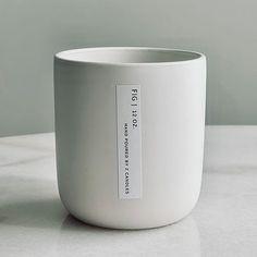 a white cup sitting on top of a table