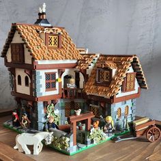 a toy house with figurines on the table