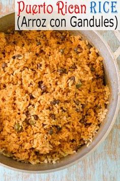 a pot filled with rice and raisins on top of a blue tablecloth