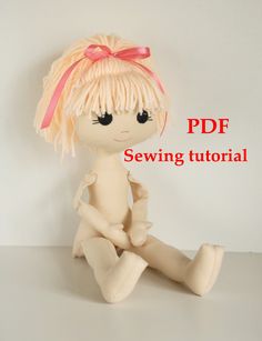 a doll sitting on the floor with text overlay that reads, free sewing pattern