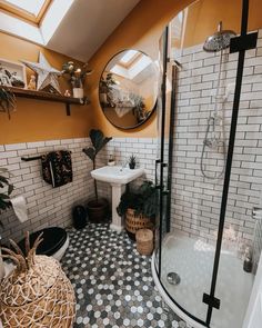 a bathroom with orange walls and black and white tile