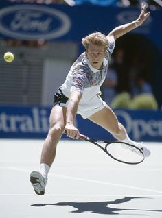 a male tennis player is in mid air after hitting the ball with his racket