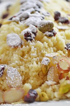 a close up of food on a plate covered in powdered sugar and cranberries