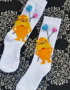 two pairs of socks with cartoon characters on them