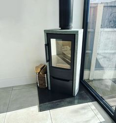 tile hearth wood stove Stove Hearth Ideas, Wood Stove Hearth Ideas, Corner Wood Stove, Stove Hearth, Hearth Ideas, Wood Stove Hearth, Freestanding Stove, Round Window