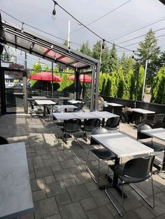 an outdoor dining area with tables and chairs