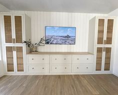 an empty living room with white walls and wood flooring