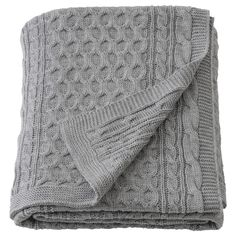 a gray blanket folded on top of each other