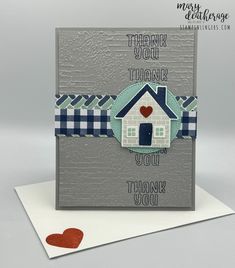 a handmade thank card with a house and heart on the front, which reads thank you