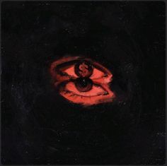 an evil looking eye in the dark with red light coming from it's center