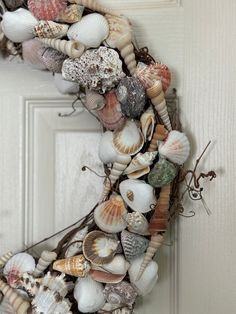 a wreath made out of seashells on a door